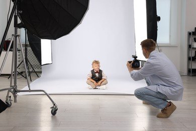 Photo of Photographer working with model in professional photo studio
