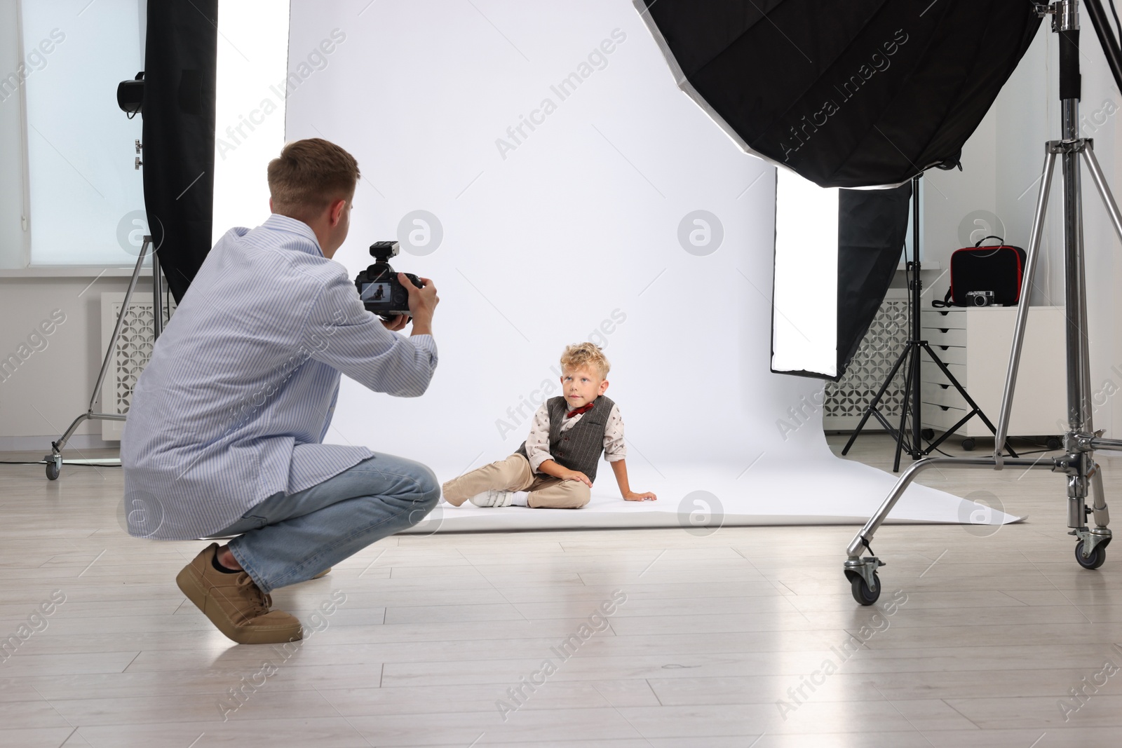 Photographer working with model in professional photo studio Photo of Photographer working with model in professional photo studio