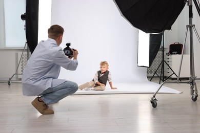 Photo of Photographer working with model in professional photo studio