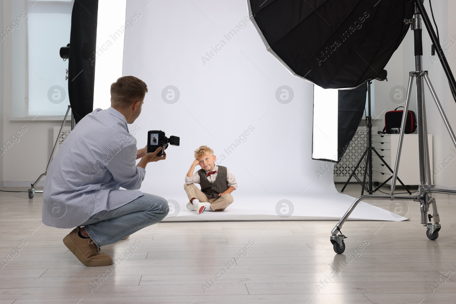 Photo of Photographer working with model in professional photo studio