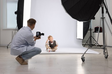 Photo of Photographer working with model in professional photo studio