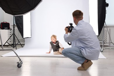 Photo of Photographer working with model in professional photo studio