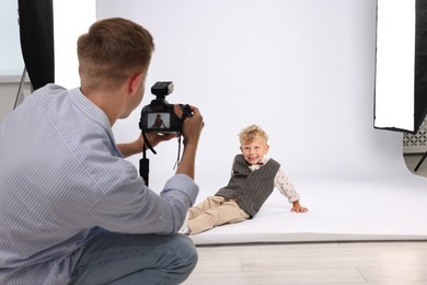 Photo of Photographer working with model in professional photo studio
