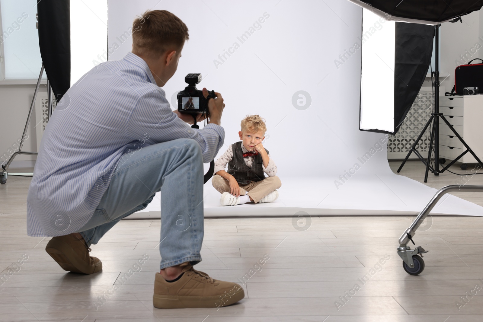 Photographer working with model in professional photo studio Photo of Photographer working with model in professional photo studio