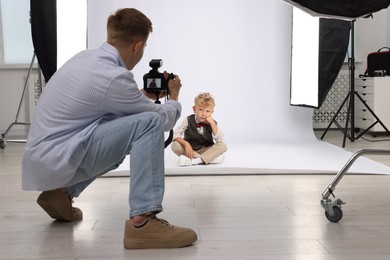Photo of Photographer working with model in professional photo studio