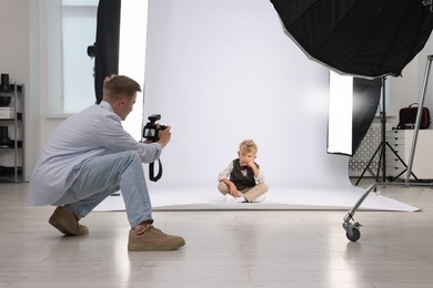 Photo of Photographer working with model in professional photo studio