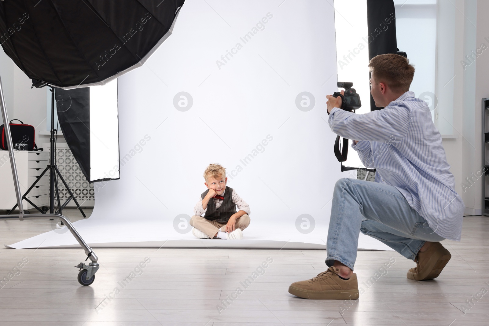 Photographer working with model in professional photo studio Photo of Photographer working with model in professional photo studio