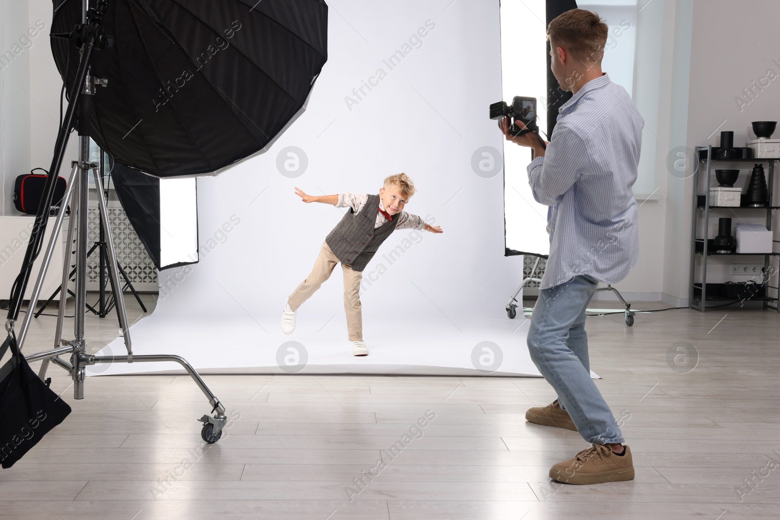 Photographer working with model in professional photo studio Photo of Photographer working with model in professional photo studio