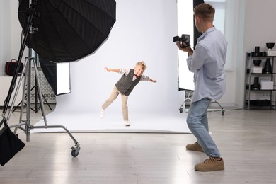 Photo of Photographer working with model in professional photo studio