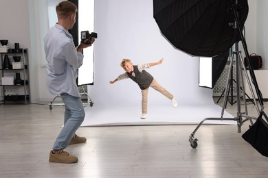 Photo of Photographer working with model in professional photo studio