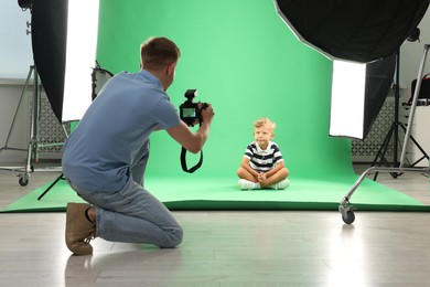Photo of Photographer working with model in professional photo studio