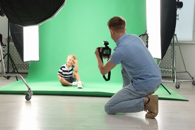 Photo of Photographer working with model in professional photo studio