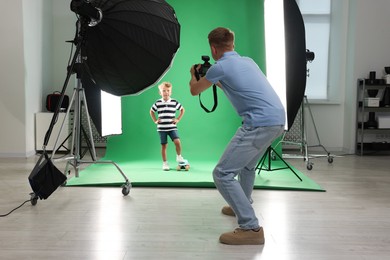 Photo of Photographer working with model in professional photo studio