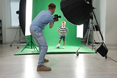 Photo of Photographer working with model in professional photo studio