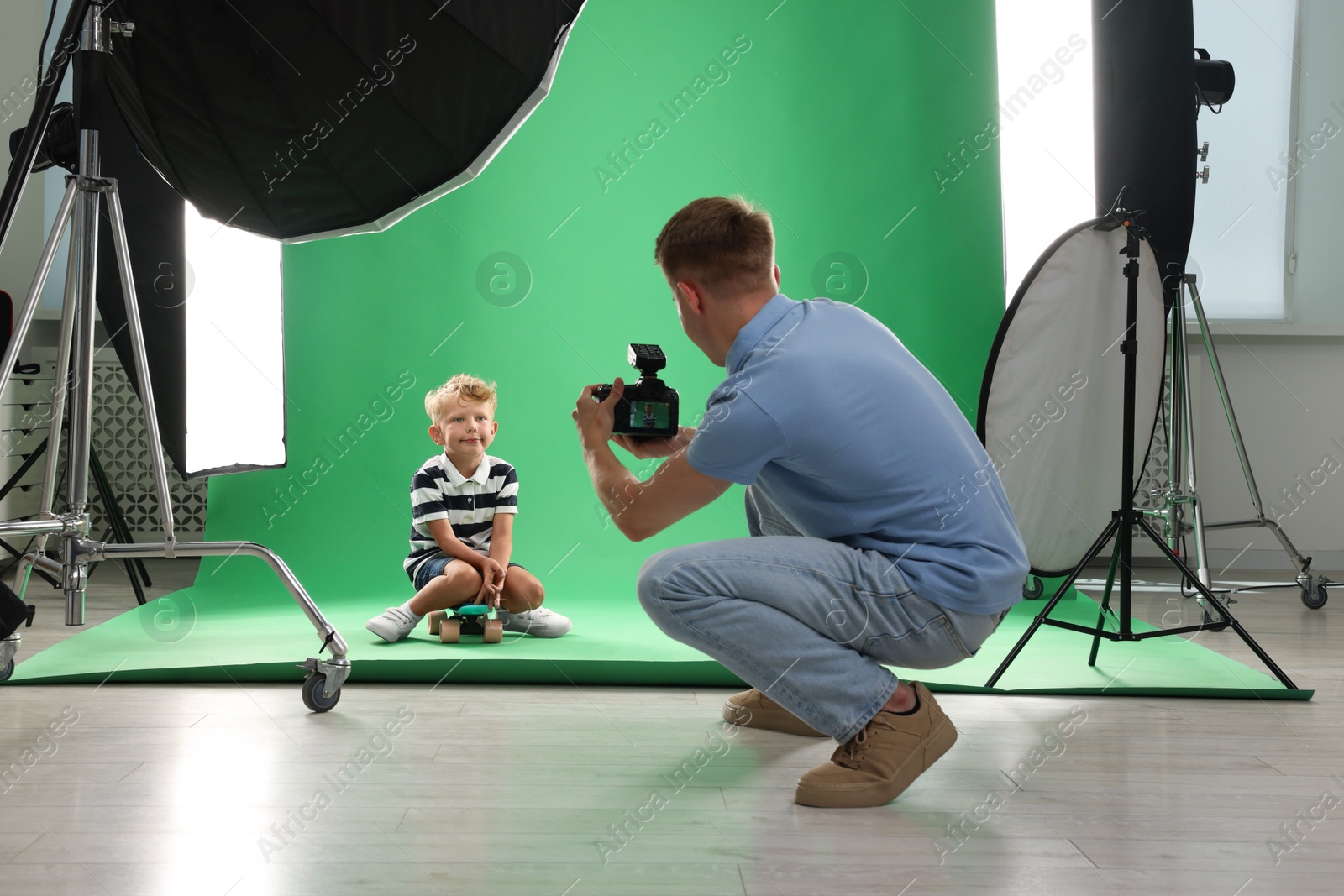 Photo of Photographer working with model in professional photo studio