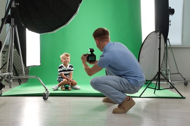 Photo of Photographer working with model in professional photo studio