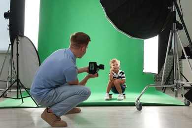 Photo of Photographer working with model in professional photo studio