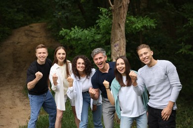 Photo of Team building. Group of happy people together outdoors