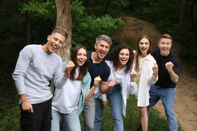 Photo of Team building. Group of happy people together outdoors