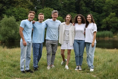 Photo of Team building. Group of happy people together outdoors