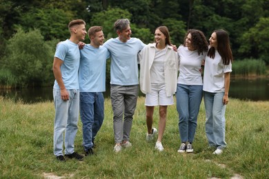 Photo of Team building. Group of happy people together outdoors