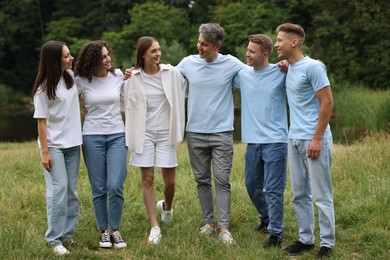 Photo of Team building. Group of happy people together outdoors