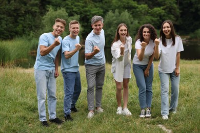 Photo of Team building. Group of happy people together outdoors