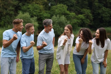 Photo of Team building. Group of happy people together outdoors