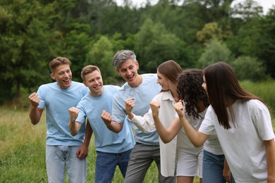 Photo of Team building. Group of happy people together outdoors