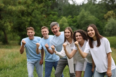 Photo of Team building. Group of happy people together outdoors