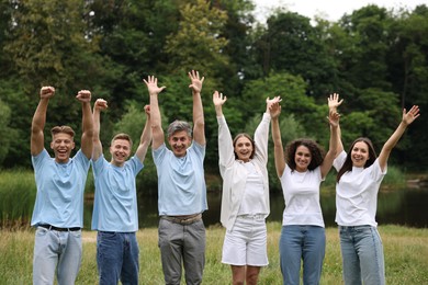 Photo of Team building. Group of happy people together outdoors