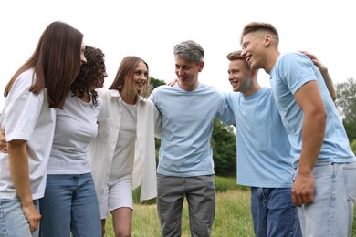 Photo of Team building. Group of happy people together outdoors