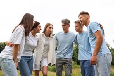 Photo of Team building. Group of happy people together outdoors