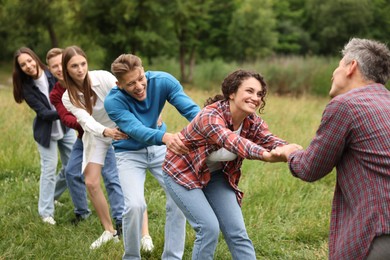 Photo of Team building. Group of happy people holding hands outdoors