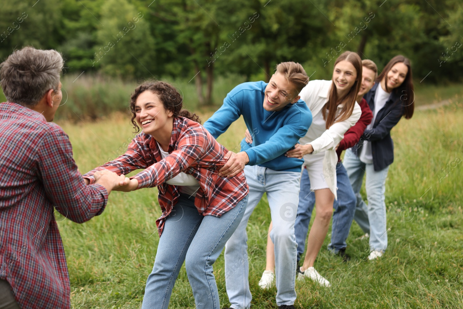 Team building. Group of happy people holding hands outdoors Photo of Team building. Group of happy people holding hands outdoors