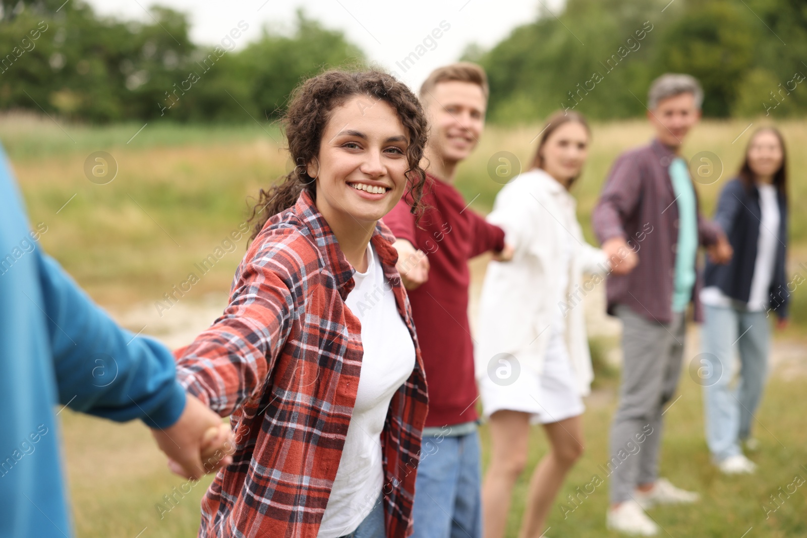 Team building. Group of happy people holding hands outdoors, selective focus Photo of Team building. Group of happy people holding hands outdoors, selective focus