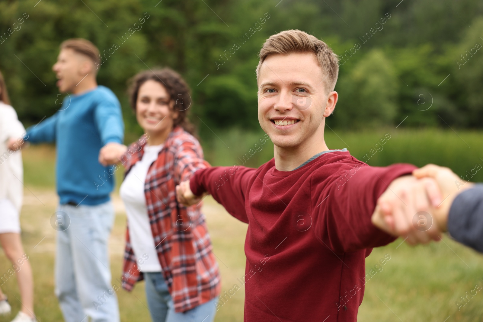 Team building. Group of happy people holding hands outdoors, selective focus Photo of Team building. Group of happy people holding hands outdoors, selective focus