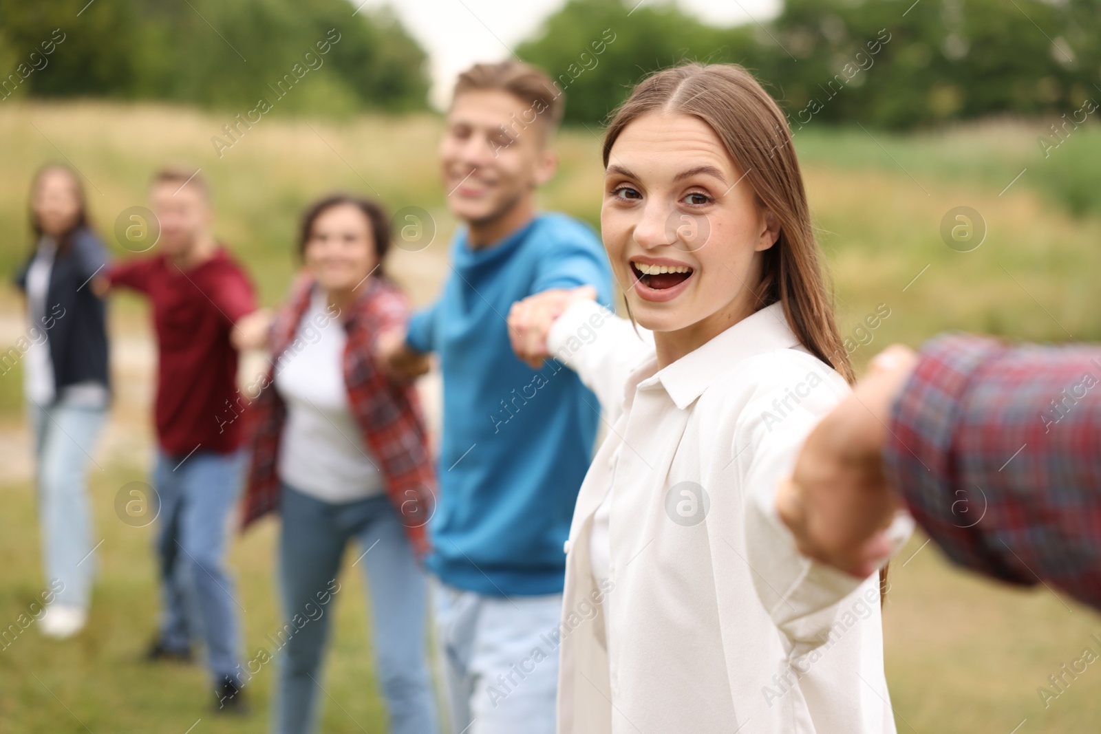 Team building. Group of happy people holding hands outdoors, selective focus Photo of Team building. Group of happy people holding hands outdoors, selective focus
