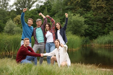 Photo of Team building. Group of happy people together outdoors