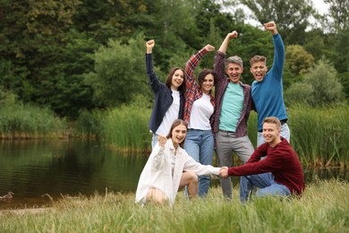 Photo of Team building. Group of happy people together outdoors