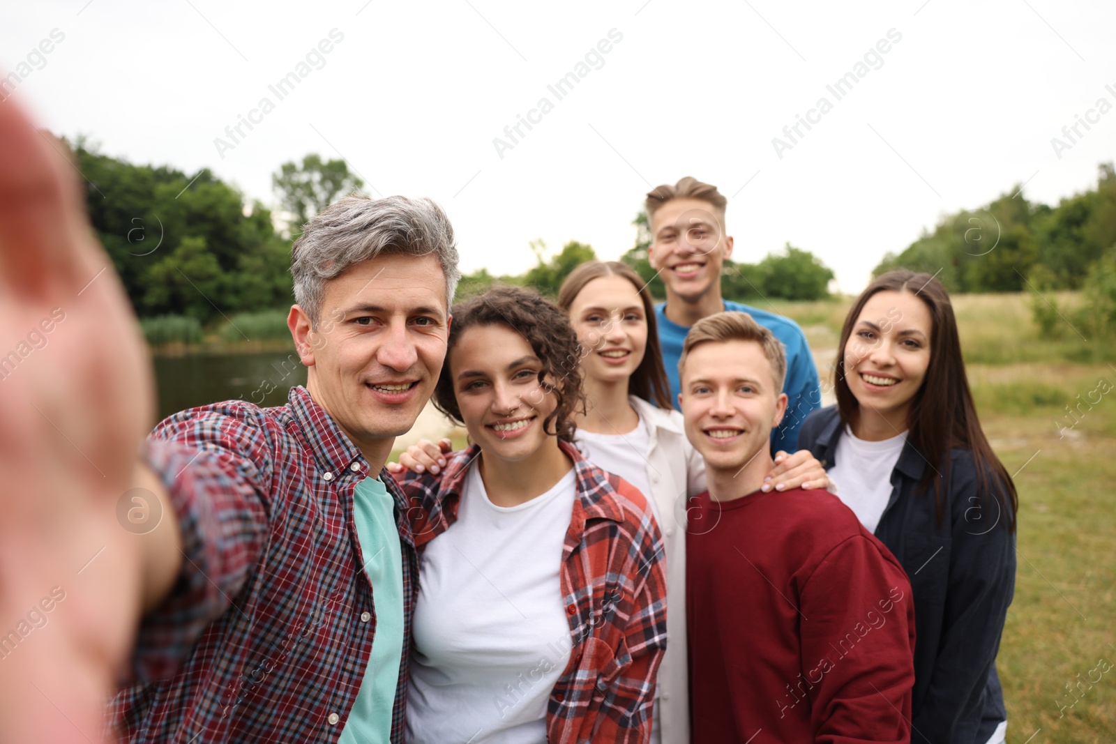 Team building. Group of happy people taking selfie outdoors Photo of Team building. Group of happy people taking selfie outdoors