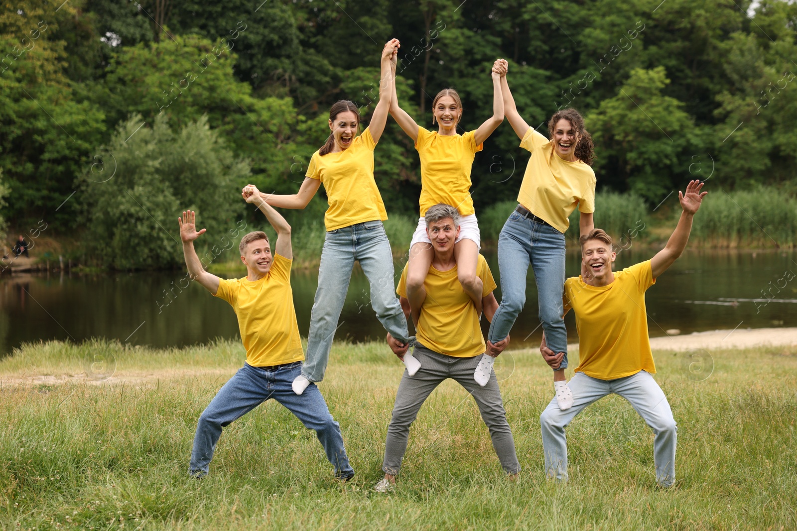 Photo of Team building. Group of happy people together outdoors