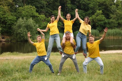 Photo of Team building. Group of happy people together outdoors