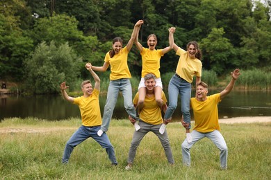 Photo of Team building. Group of happy people together outdoors