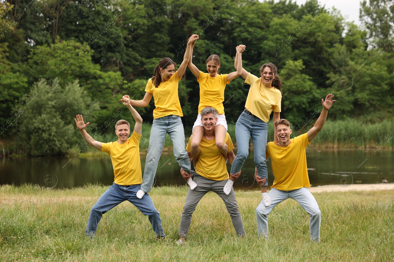 Photo of Team building. Group of happy people together outdoors