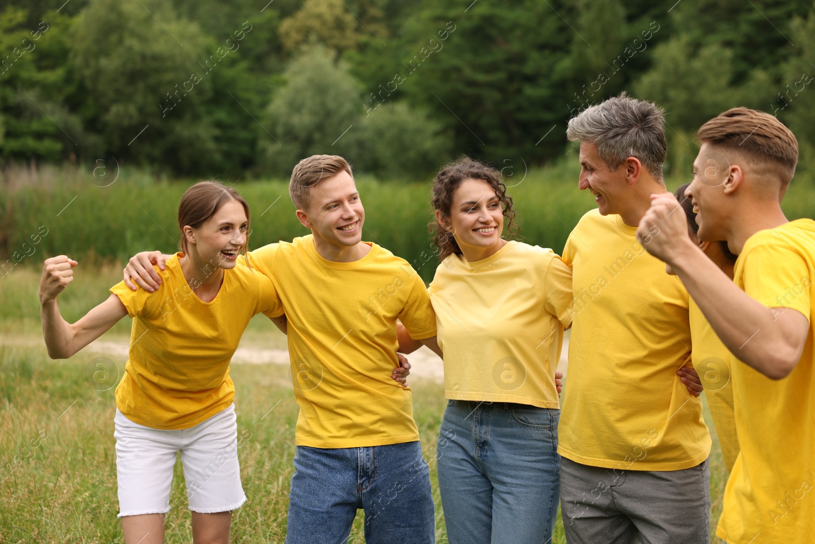 Photo of Team building. Group of happy people together outdoors