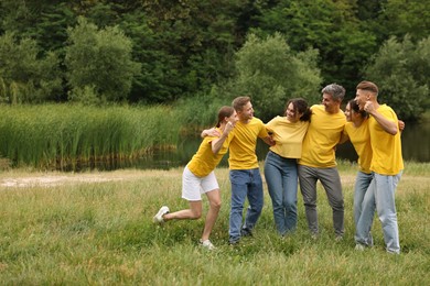 Photo of Team building. Group of happy people together outdoors