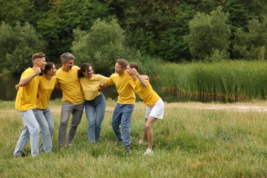 Photo of Team building. Group of happy people together outdoors