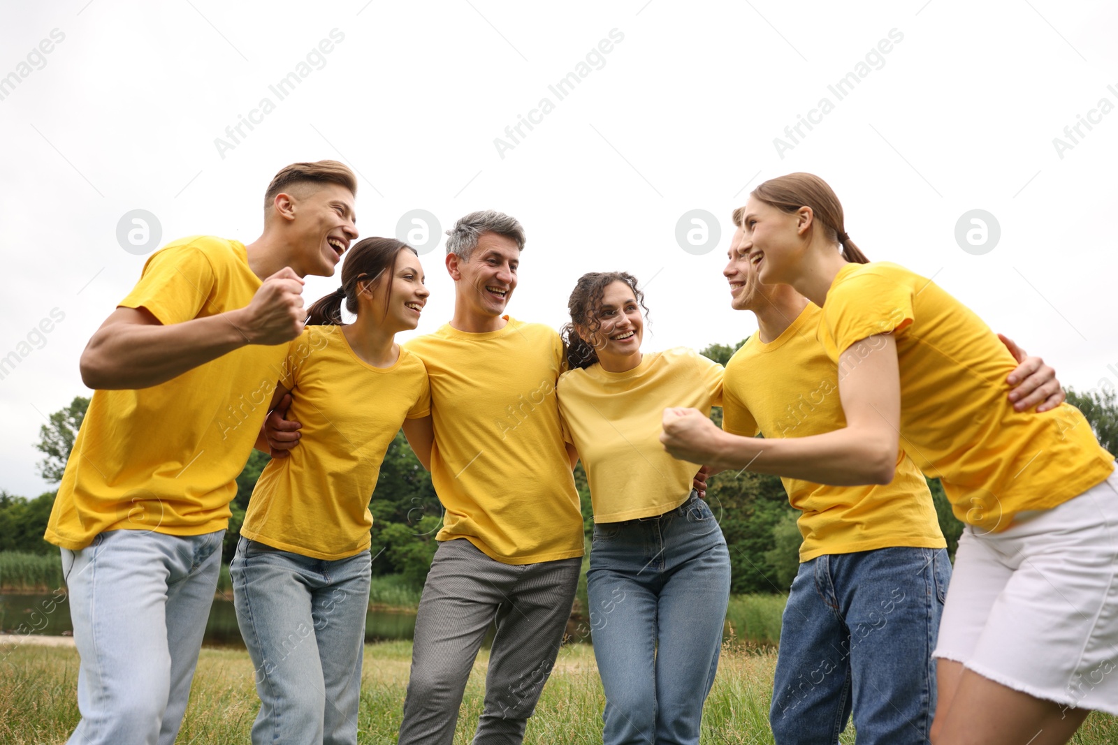 Photo of Team building. Group of happy people together outdoors