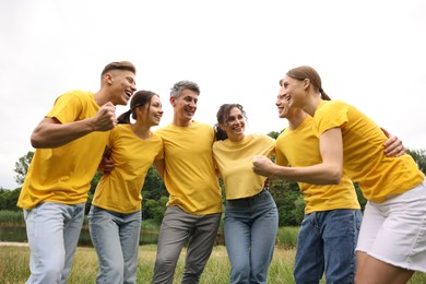 Photo of Team building. Group of happy people together outdoors